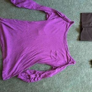 Woman’s purple top with sleeves that button to 3/4